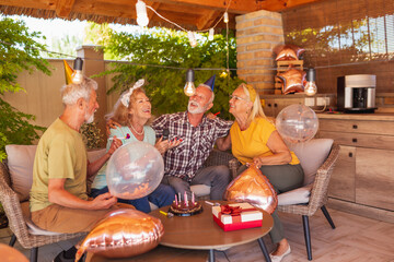 Senior friends having a karaoke birthday party