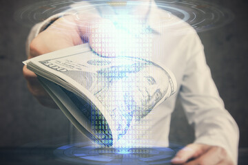 Double exposure of technology drawing hologram and us dollars bills and man hands. Data concept