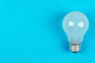 Light bulb on a blue background on the right. Top view