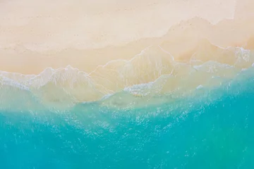 Fototapeten Top view on coast waves on beach aerial view, crystal clear water. Stunning summer landscape, sunny tropical island shore. Seaside, idyllic nature Earth view. Stunning scenery, amazing view © icemanphotos
