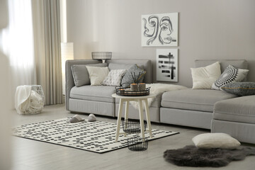 Cozy living room interior with big grey sofa