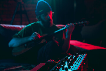 Close-up of musician performing in neon light. Concept of advertising, hobby, music, festival, entertainment.