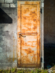 Detail of a rusty door of a factory. Frontal view
