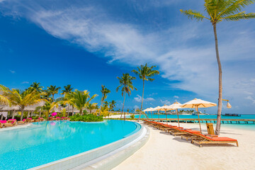 Relax tourism landscape. Luxurious beach resort with swimming pool and beach chairs or loungers...