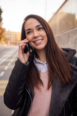 portrait of a woman making a call on the street