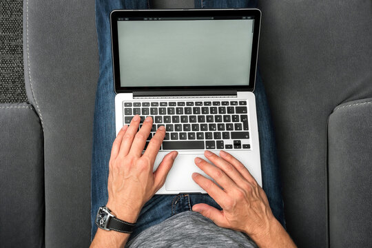 Mann mit Laptop auf Sofa. (Vogelperspektive)