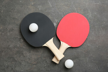 Ping pong rackets and balls on grey table, flat lay