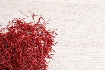 Naklejka premium Dried saffron on white wooden table, flat lay. Space for text