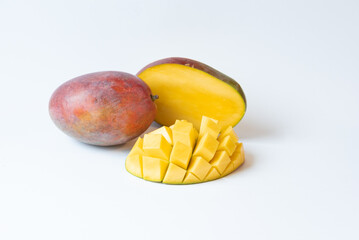 Isolated, cut, juicy and ripe mango fruit on a white background