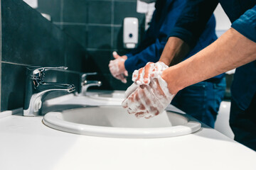 close up. employees wash their hands thoroughly