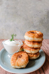 A stack of white Meat pies on a gray plate. Traditional Muslim dish. Arafat, Eid Al Adha.Place for text. Vertical.