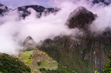 landscape with mountain in clouds and fog with Machu Picchu in distance 