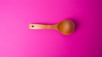 wooden spoon for food on a colored background. old vintage spoon