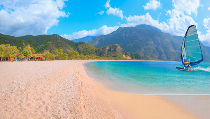 Beautiful cloudy sky with Windsurfer Surfing The Wind On Waves - Panoramic view of Oludeniz Beach And Blue Lagoon, Oludeniz beach is best beaches in Turkey - Fethiye, Turkey