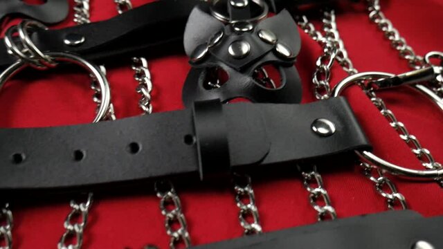 A set of erotic toys for BDSM. Sex slavery game with whip, gag and leather face mask. Intimate sex games leather belts