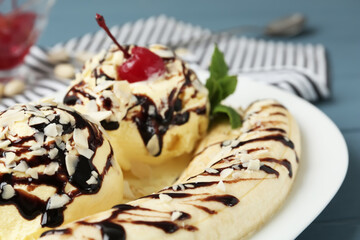 Delicious dessert with banana ice cream on table, closeup