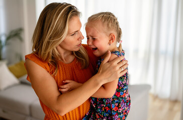 Mother comforting her crying little girl. Parenthood, family, support concept