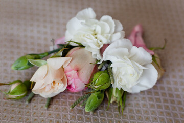 Delicate wedding boutonniere from pink and white flowers