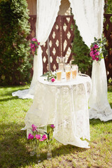 Details of wedding ceremony and tradition of making family amulet from different grain, outdoor. Peony decorations in the wedding celebration