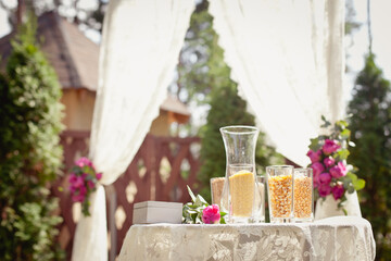 Details of wedding ceremony and tradition of making family amulet from different grain, outdoor....