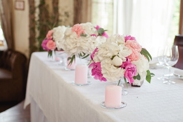 Wedding ceremony decoration in the restaurant. Decoration of wedding table with tender pink textile