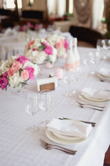 Wedding ceremony decoration in the restaurant. Decoration of wedding table with tender pink textile