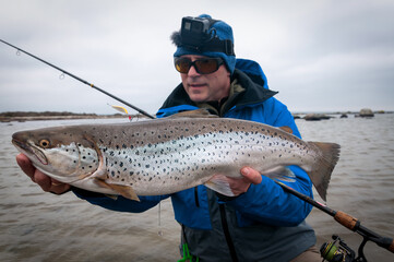 Angler with beautiful silver sea trout