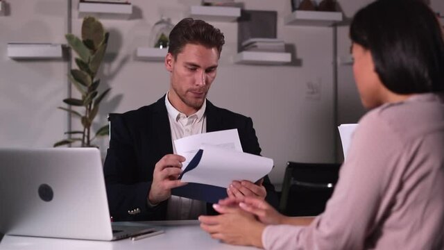 HP specialist man interviews woman for vacancy in large office Spbi.