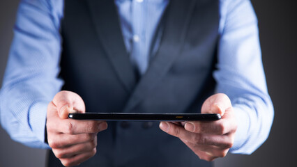 man holding digital tablet device in hands