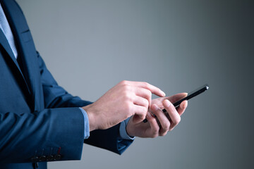young business man holding phone