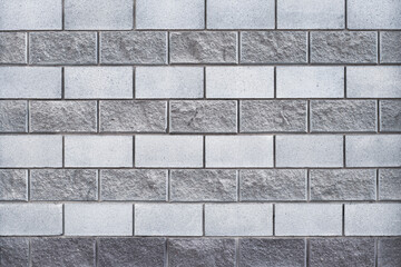 Gray brick wall, masonry pattern, concrete background, cement block texture, grunge architectural element. Abstract backdrop. Building's facade. Urban design.