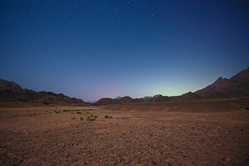 Fototapeta na wymiar Barren desert landscape in hot climate at night