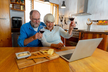 COVID-19 outbreak. Senior couple video calling family celebrating easing of coronavirus lockdown