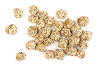 Caramelized hazelnut balls with sesame seeds, dessert isolated on white background, top view