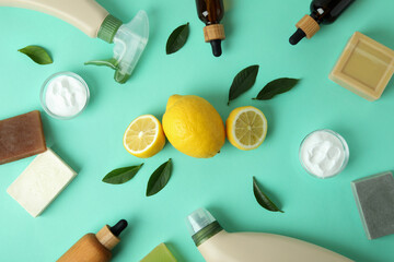 Fototapeta na wymiar Cleaning concept with eco friendly cleaning tools and lemons on mint background