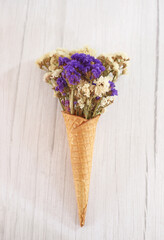 decorative ice cream cone with dried flowers - spring background theme