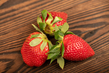 Fresh strawberries on a wooden table. Harvesting.