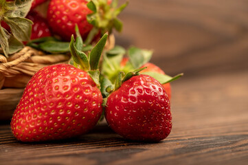 Fresh strawberries on a wooden table. Harvesting.