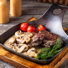 Veal medallions with mushroom sauce. Meat medallions