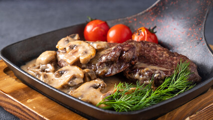 Meat medallions with tomatoes and mushroom sauce