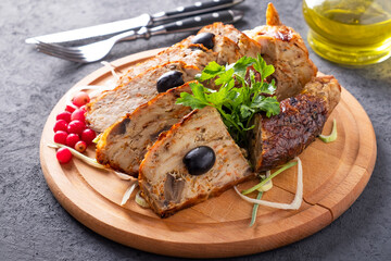 Stuffed chicken with pancakes and mushrooms on a wooden board