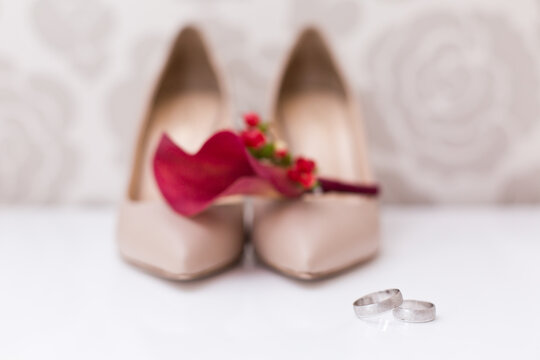 Wedding accessories: bride's shoes, rings and boutonniere