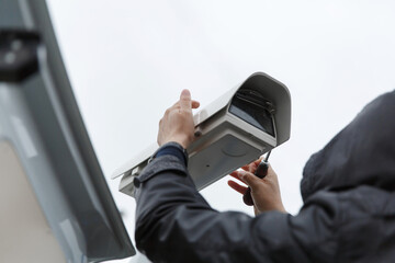 Мan installing a CCTV camera