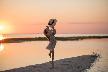 Fototapeta premium Beautiful little girl jumping on the beach 