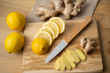 Ginger with lemon detox water in the morning on wooden background