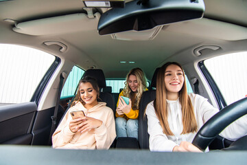 Three best friends in the car and use smart phone while one woman drive car