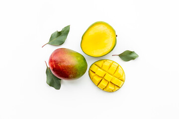 Mango fruit and mango cubes top view. Tropical fruits background