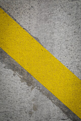 Grey asphalt with yellow stripe, 
yellow marks on road, for background with space for text, abstract backdrop like race or transportation