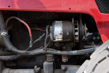 Old tractor engine and generator belt with open wires and terminals, mechanics and industry...