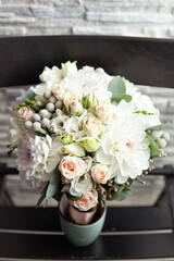 delicate Bride's bouquet with tea roses, white dahlias and brunei
